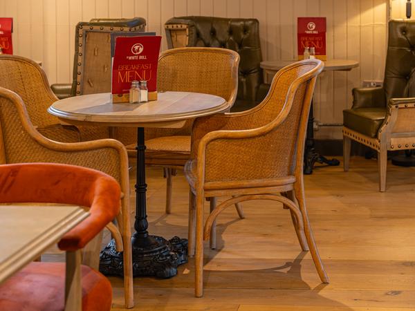 Wicker chairs and a leather wingback in the lounge corner