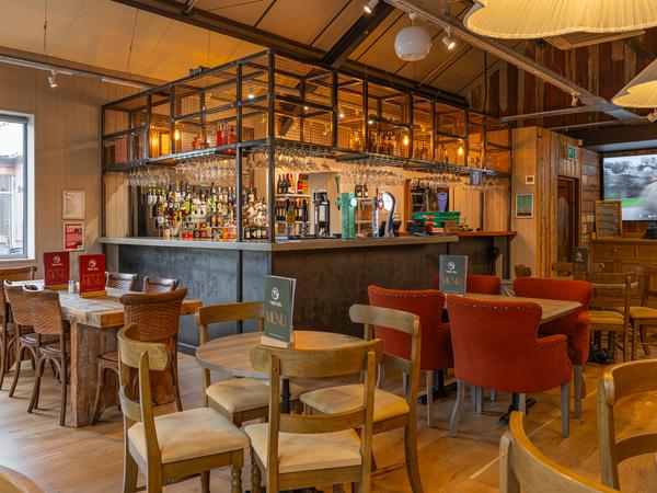 High tables and bar seating by the back bar